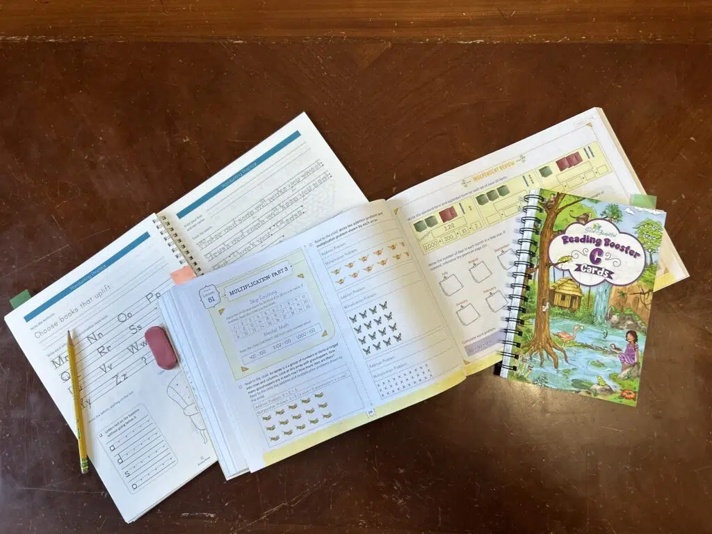Homeschooling 2nd Grade This Year - What We Used The good and the beautiful language arts displayed on a table.