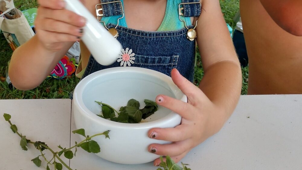 Girl crushing herbs