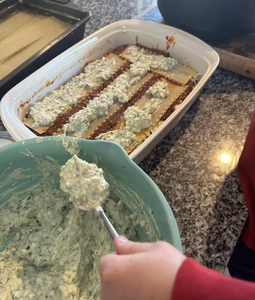 My son working on spreading the cottage cheese mixture!