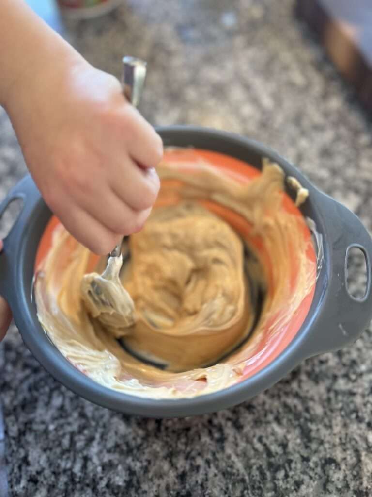 Mixing the two ingredients in a mixing bowl.