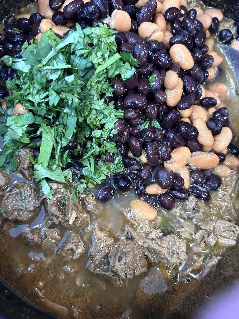 Return the shredded beef to the dutch oven and add the beans, lime juice and cilantro.