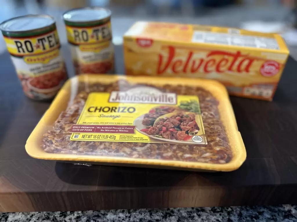 Chorizo Crock pot dip ingredients including Johnsonville chorizo, velveeta cheese, and 2 cans of rotel tomaotes.