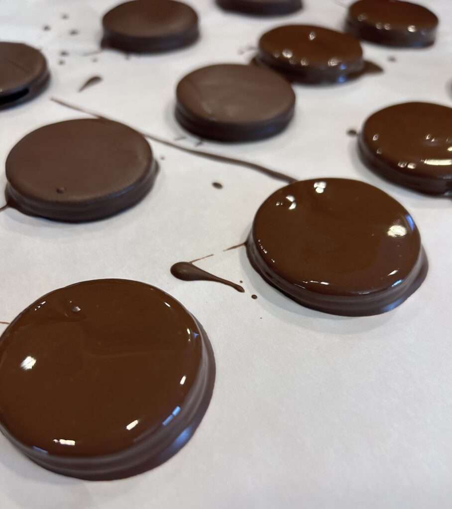 Oreo Thin mints on a parchment lined cookie sheet.