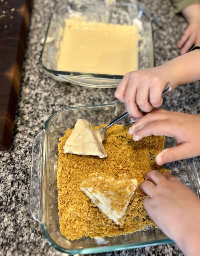 My sons dipping the battered frenchee quaters into the crushed corn flakes.