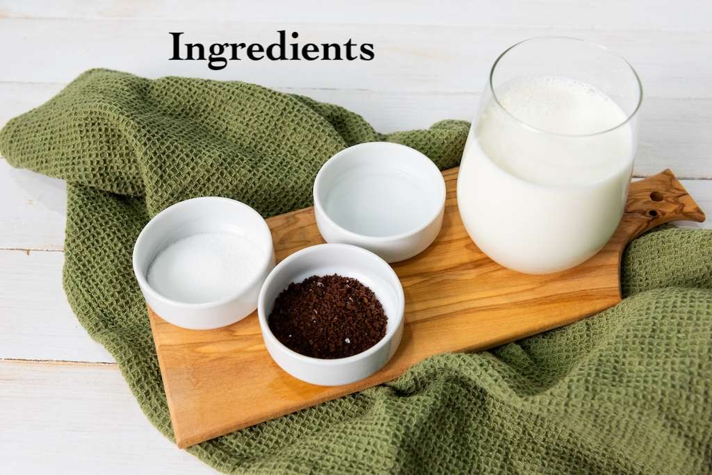 The 4 ingredients required to make a Dalgona whipped coffee including milk, sugar, instant coffee and water.