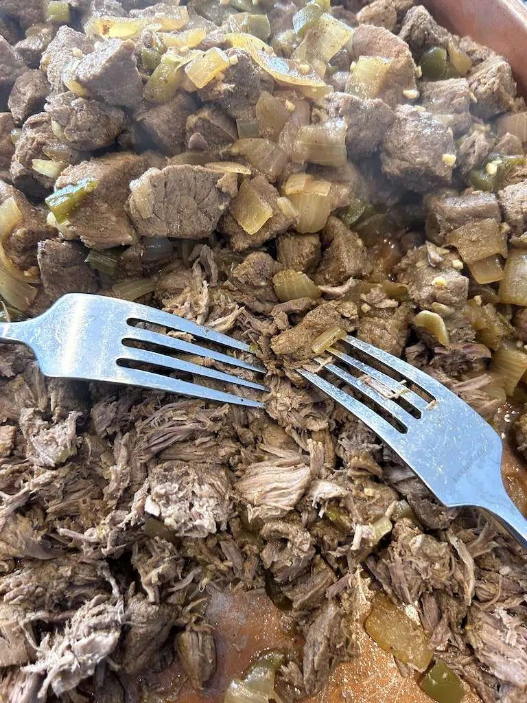 Shred the beef for the chimichanga filling.