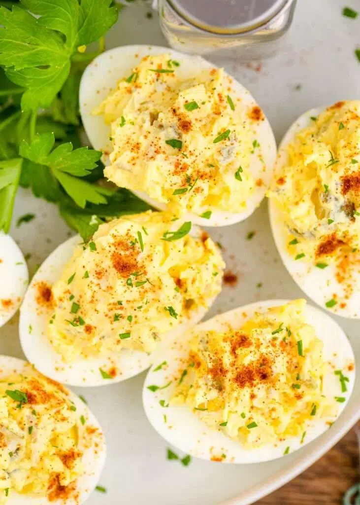 Creamy deviled eggs with paprika and parsley garnish