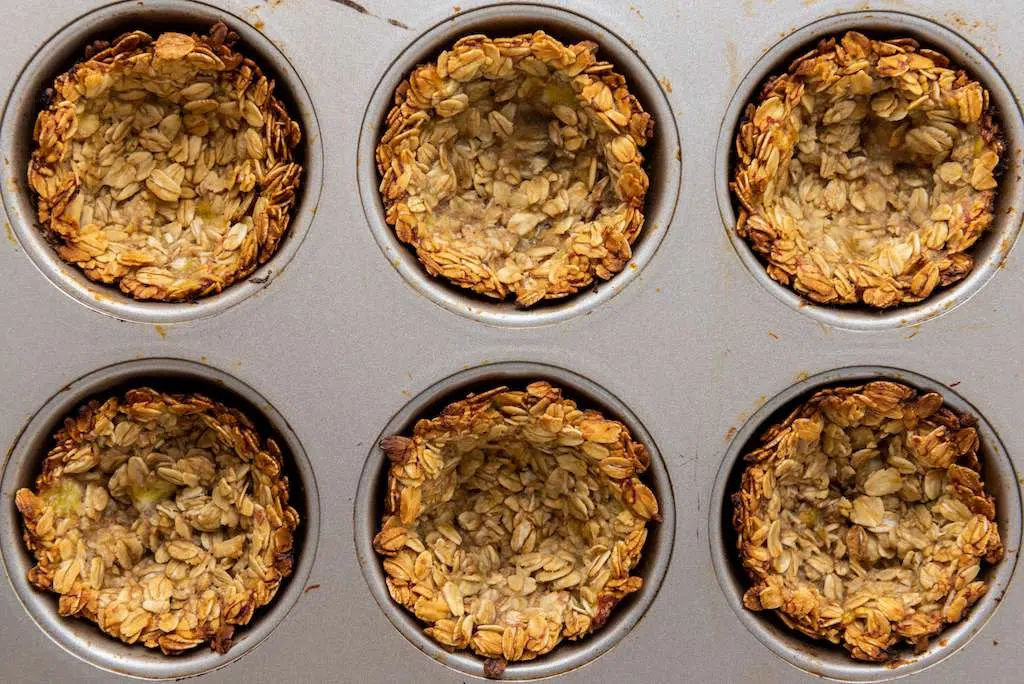 Granola Berry Cups - A Delicious Treat Baked mini granola cups in a muffin tin.