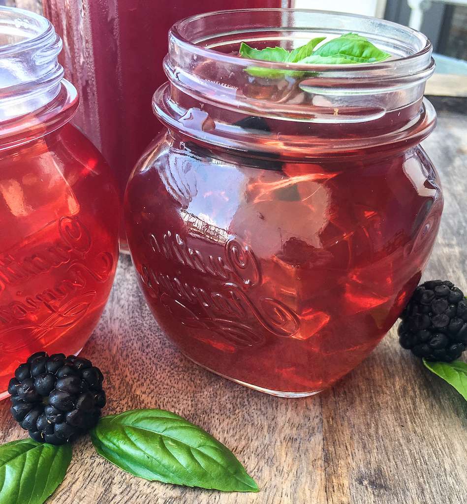 Glass of blackberry iced tea garnished with fresh basil - Instant Pot drink Recipes.