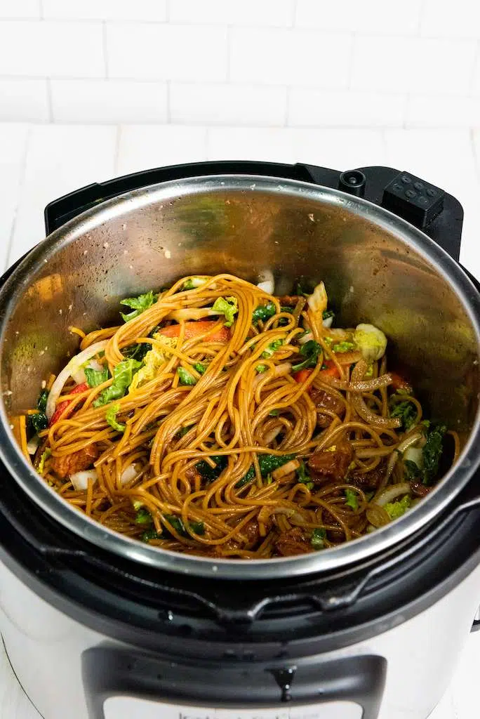 Easy Instant Pot Pork Lo Mein Recipe Mixing the veggies and noddles together for instant pot pork lo mein