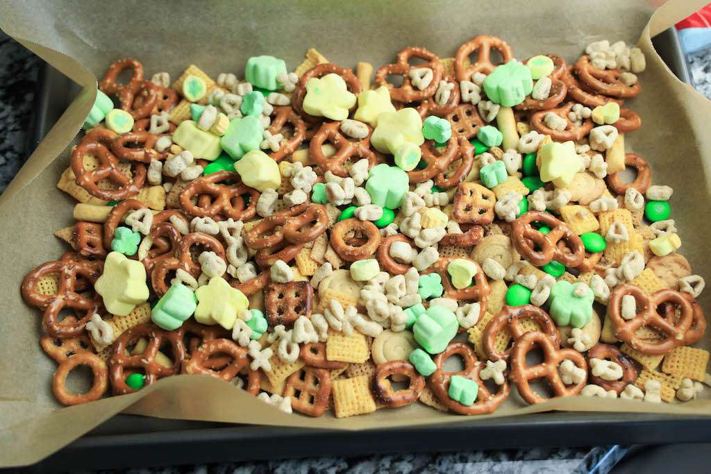 The dry ingredients for leprechaun food on a parchment lined cookie sheet.