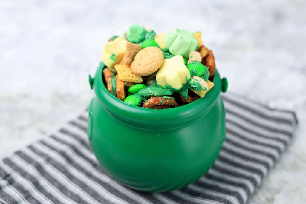 Leprechaun bait in a green cauldron on a black and white stripped napkin.