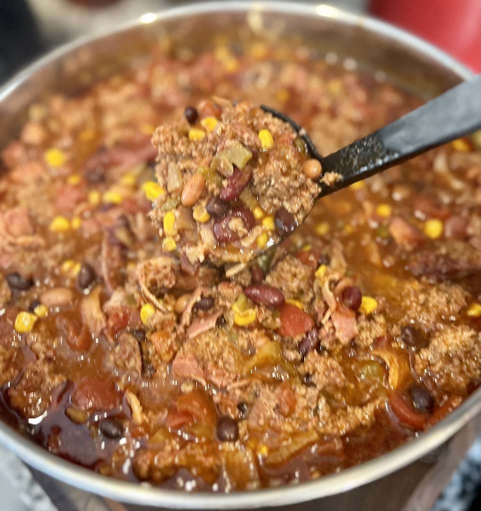 A large pot of OTT chili being served with a ladel.