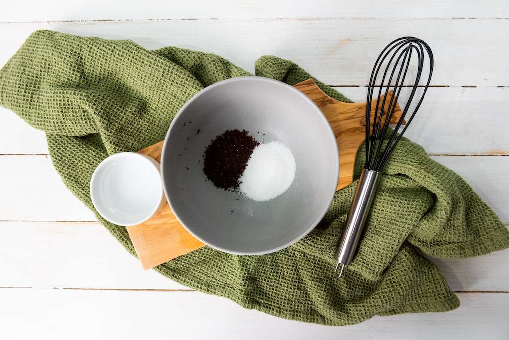 Three ingredients for making a whipped Dalgona latte including water, instant coffee and sugar.