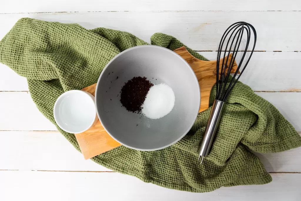 Three ingredients for making a whipped Dalgona latte including water, instant coffee and sugar.