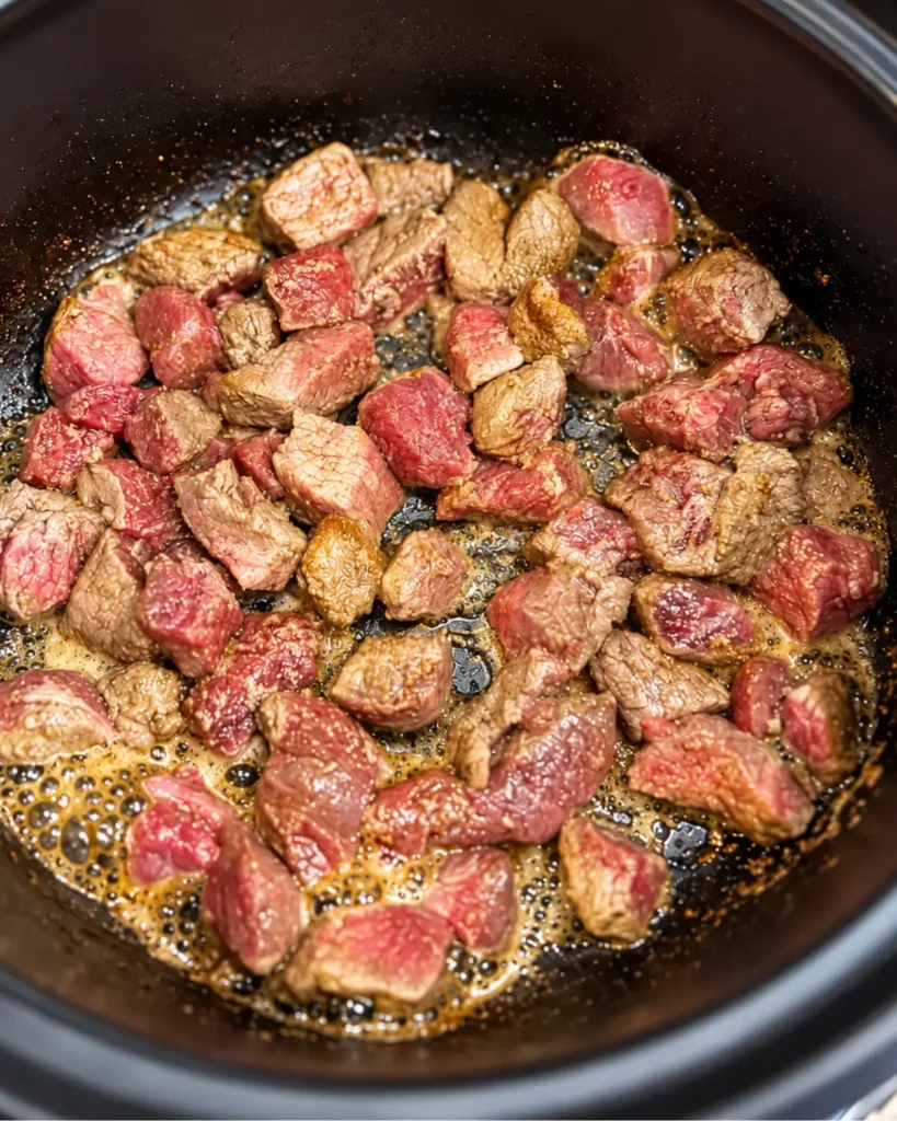 Browning shredded beef in a pan for chimichangas recipe
