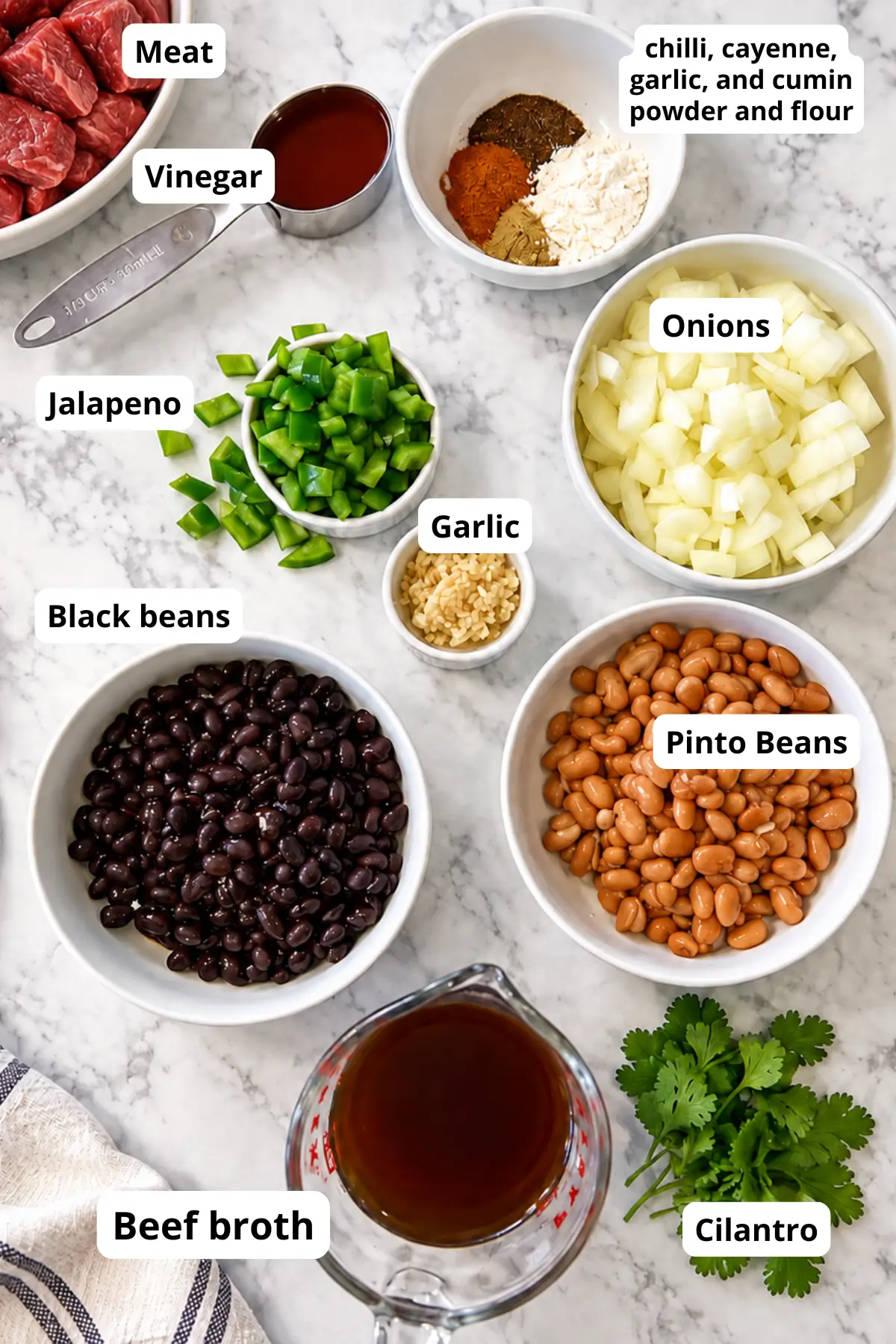 Ingredients for homemade shredded beef chimichangas including beans, meat, and spices.