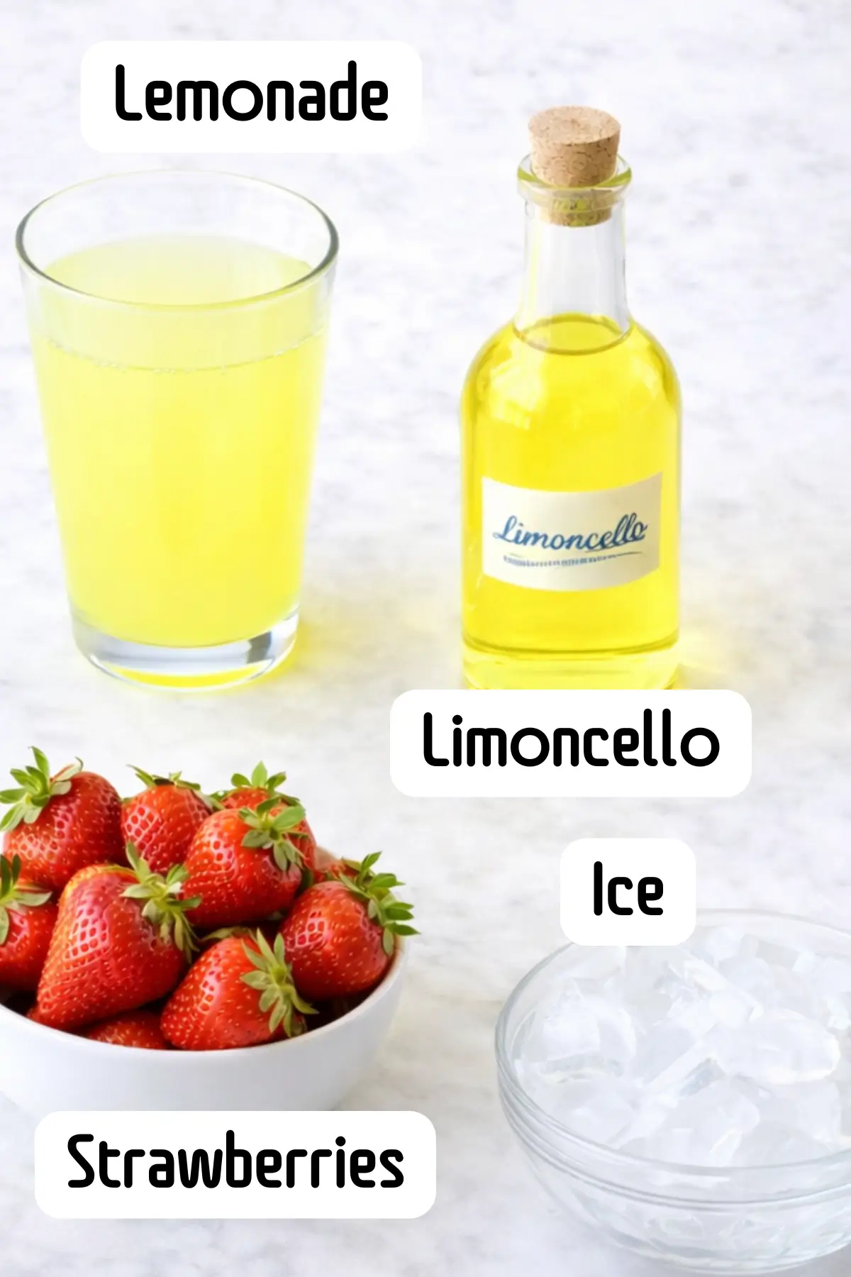 Ingredients for strawberry limoncello lemonade: glass, bottle, bowl of strawberries, and ice.