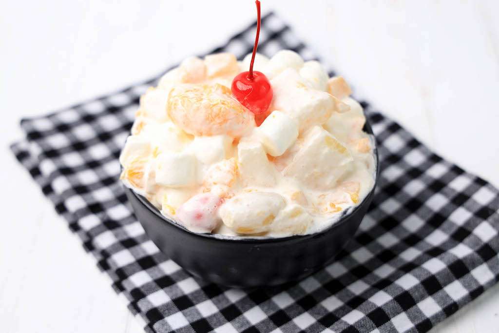 ambrosia salad with cool whip in a black bowl