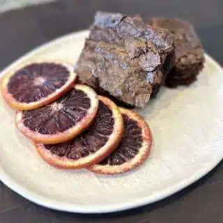 Blood Orange Brownies platted with slices of blood oranges