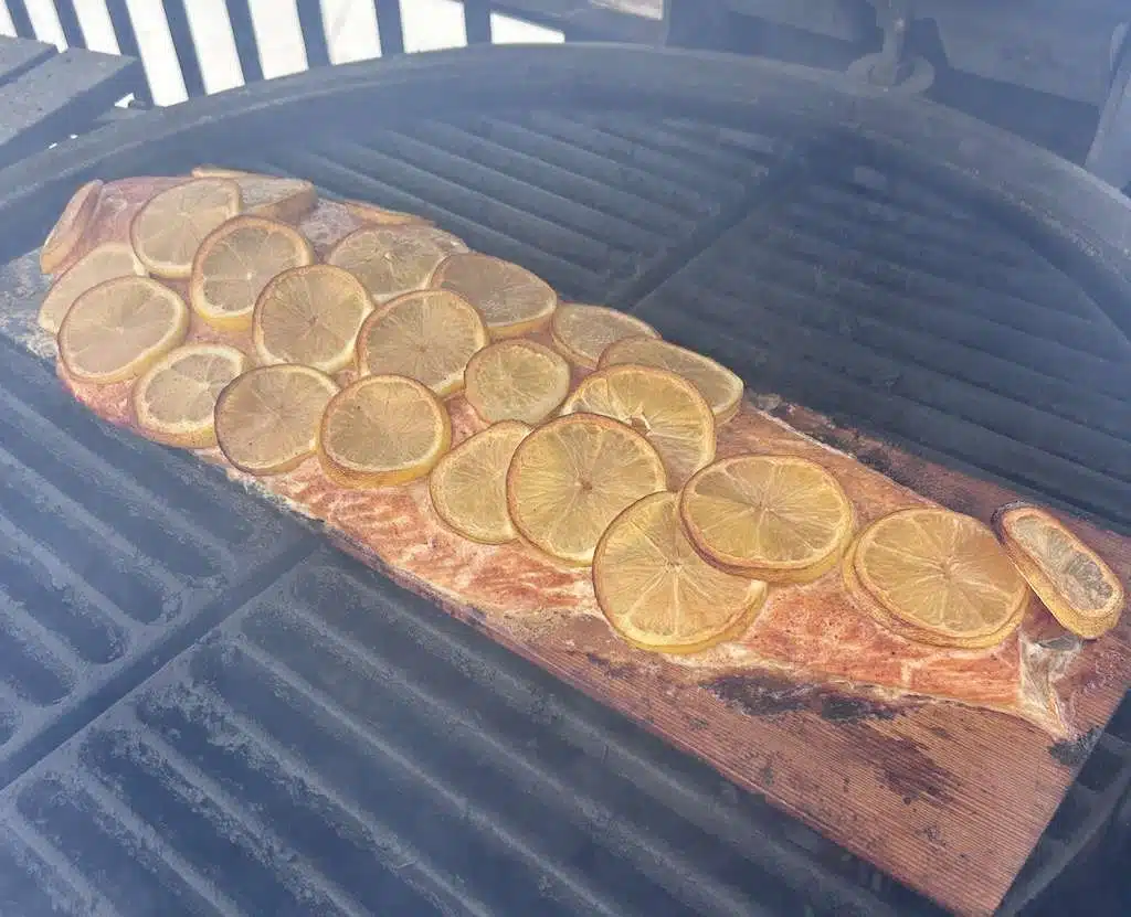 Kamado Joe cedar planked salmon grilling on the grill.