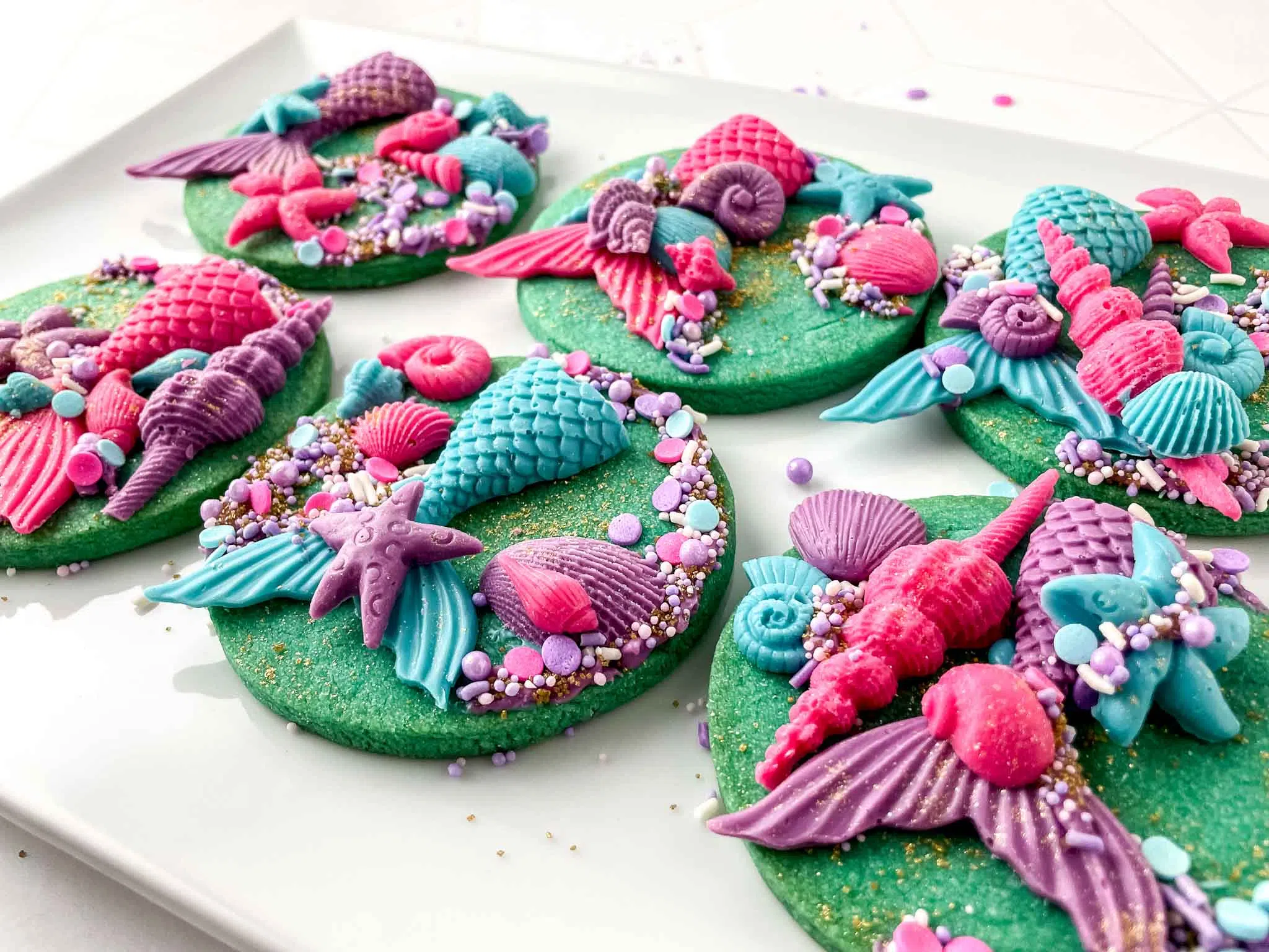 Mermaid seashell sugar cookies with colorful fondant and sprinkles