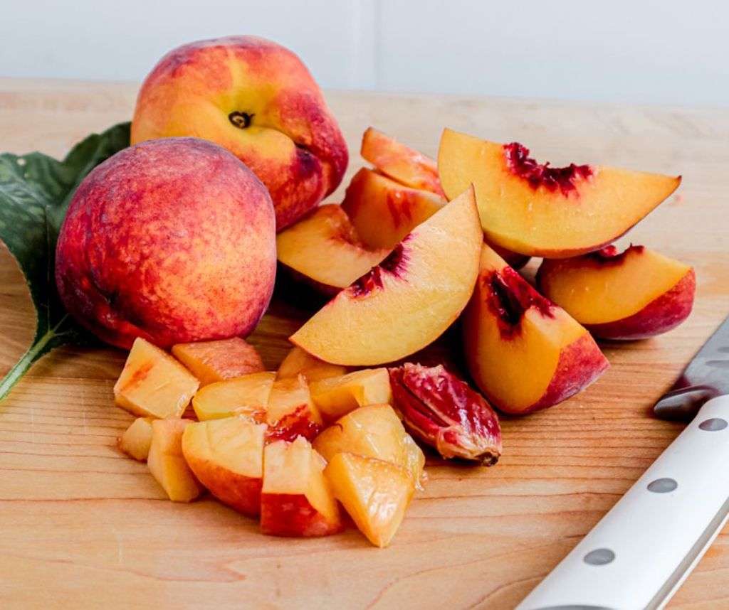 fresh peaches on a cutting board