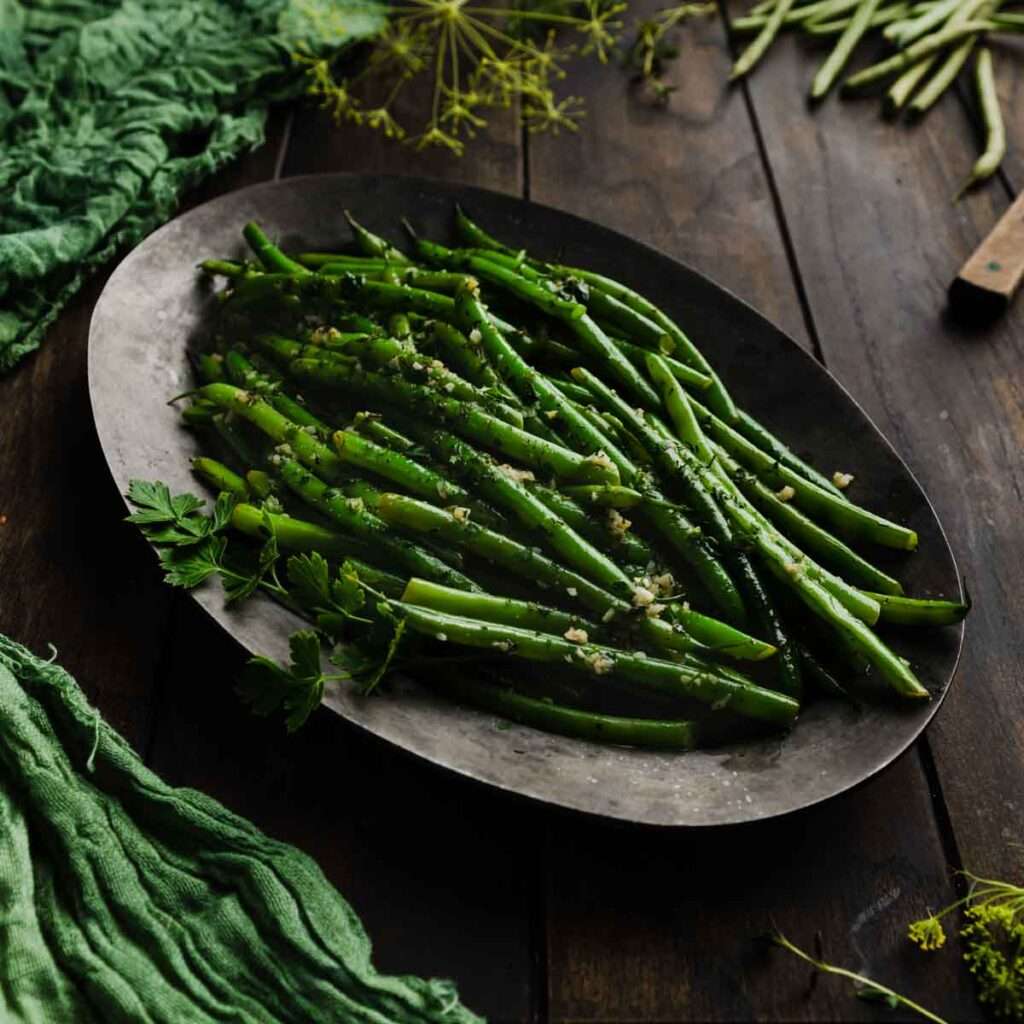Garlic herb green beans on a rustic serving platter