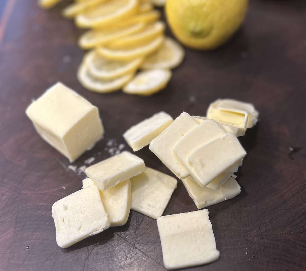 Sliced butter and lemons for topping the cedar planked salmon.