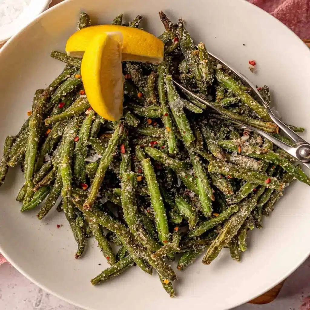 Crispy roasted green beans with Parmesan, red pepper flakes, and lemon wedges