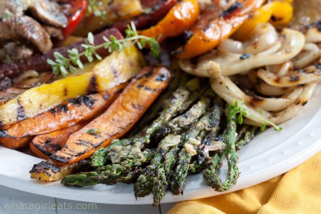 Grilled vegetables on plate: asparagus, carrots, peppers, onions, squash