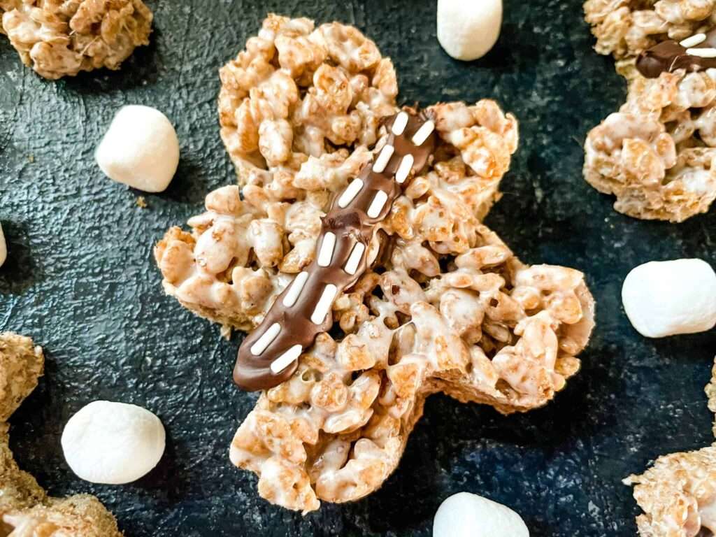 Shamrock Rice Krispies treat with chocolate drizzle and mini marshmallows