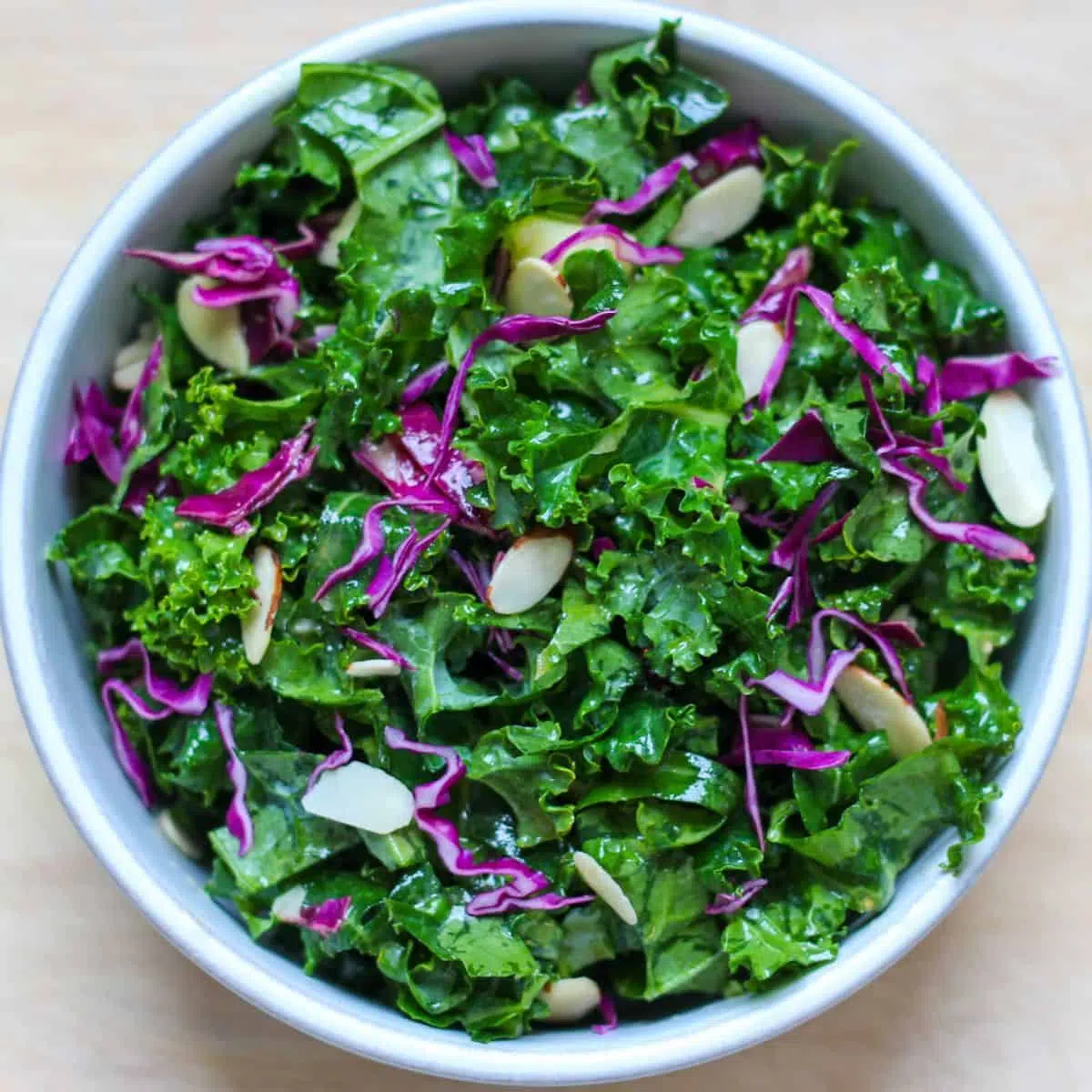 16 Delicious Side Dishes for Beef Stroganoff Fresh kale salad with red cabbage and sliced almonds in a bowl