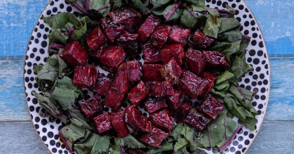 Balsamic roasted beets on beet greens, overhead view