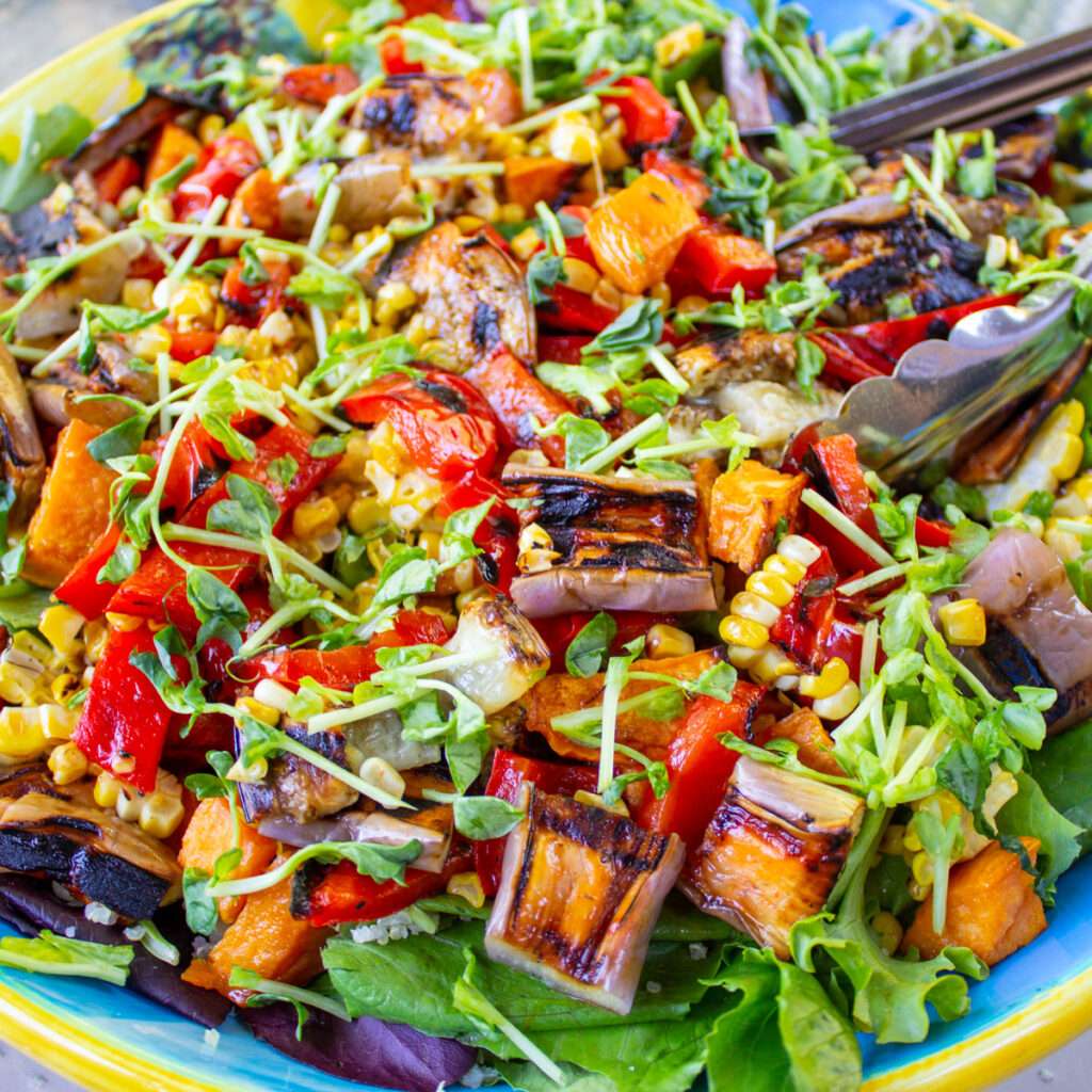 Grilled vegetable salad with eggplant, bell peppers, corn, and microgreens