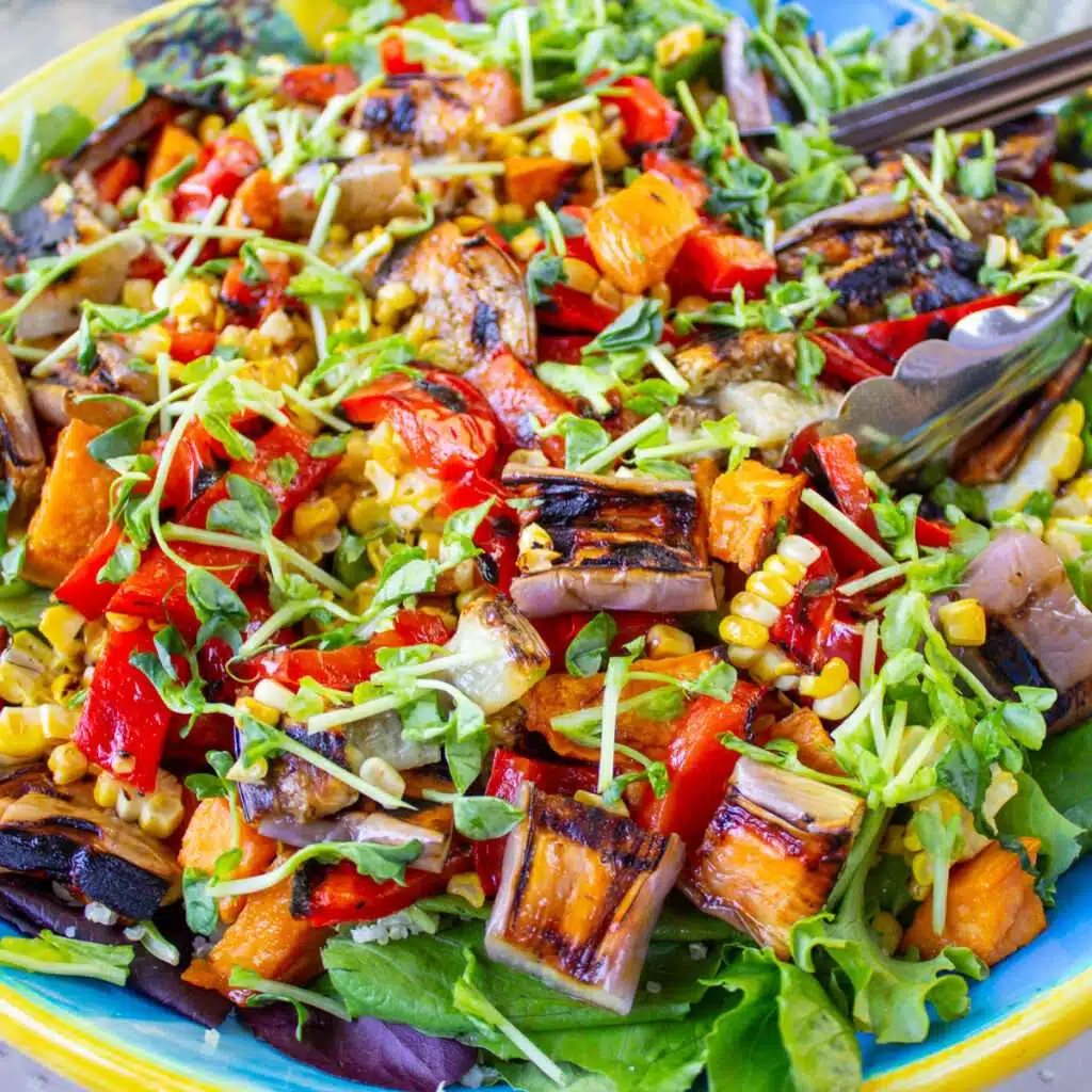 Grilled vegetable salad with eggplant, bell peppers, corn, and microgreens