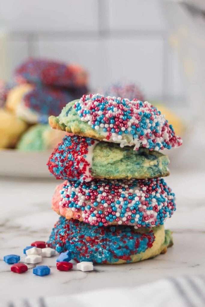 Stack of patriotic sugar cookies with red, white, and blue sprinkles.