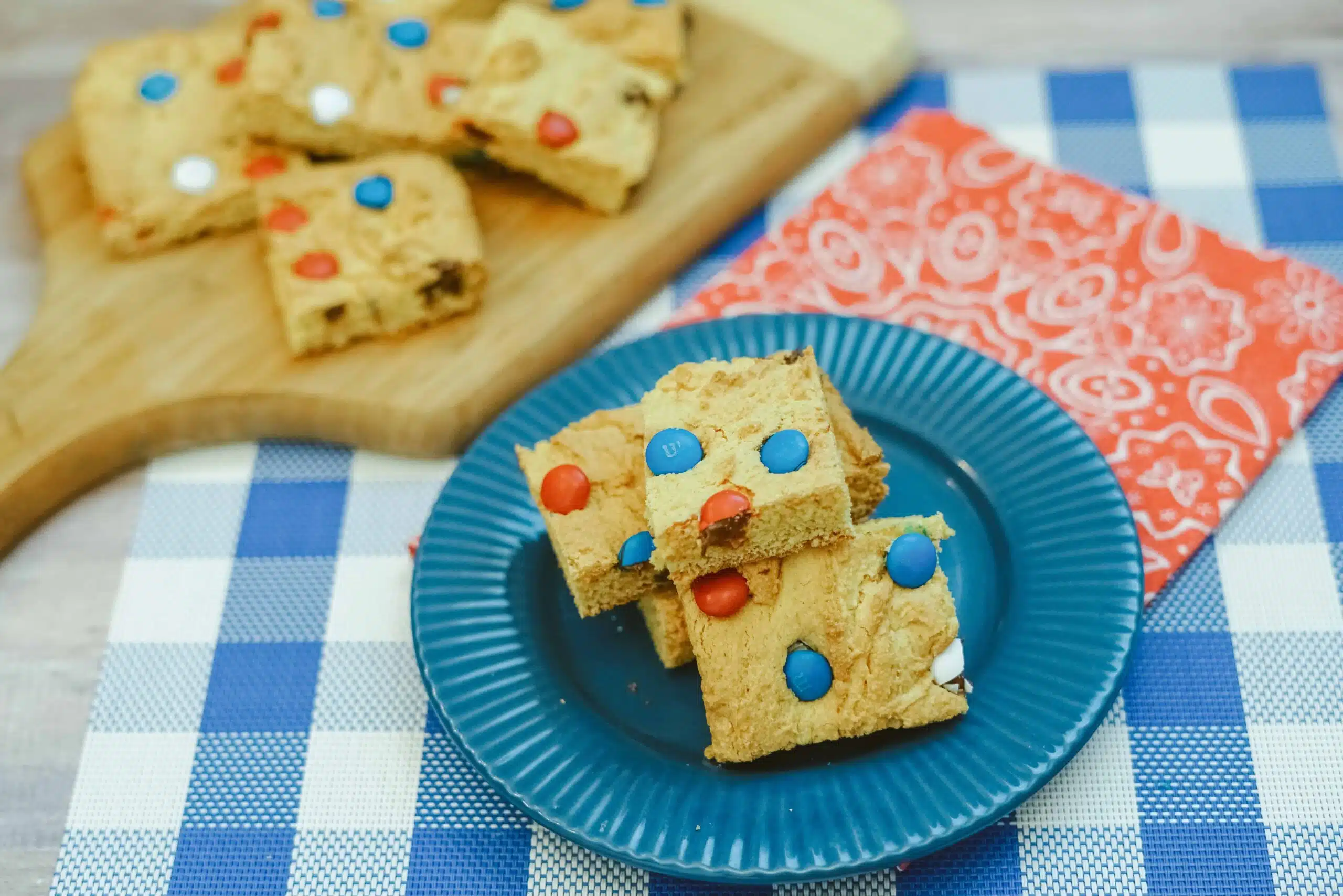 Patriotic M&M cookie blondie bars on a teal plate