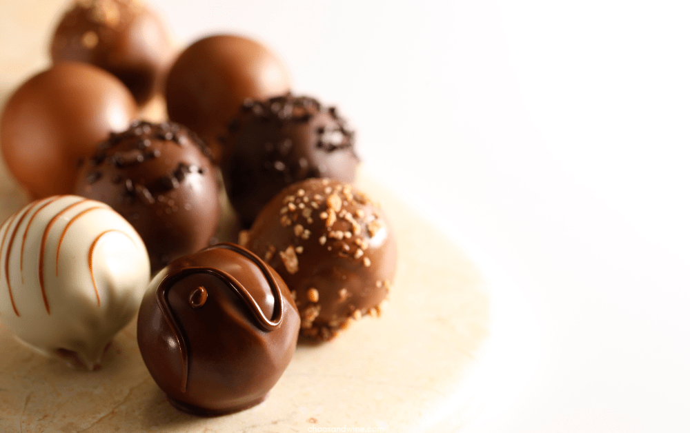 Oreo cookie balls decorated with various garnishes on a white background.