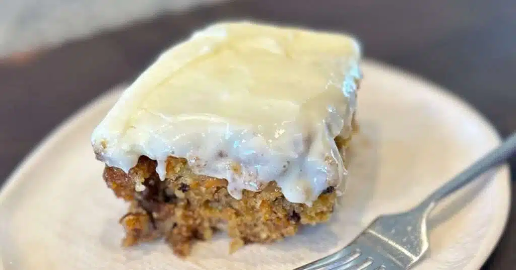 Carrot Cake on a white plate with a fork.