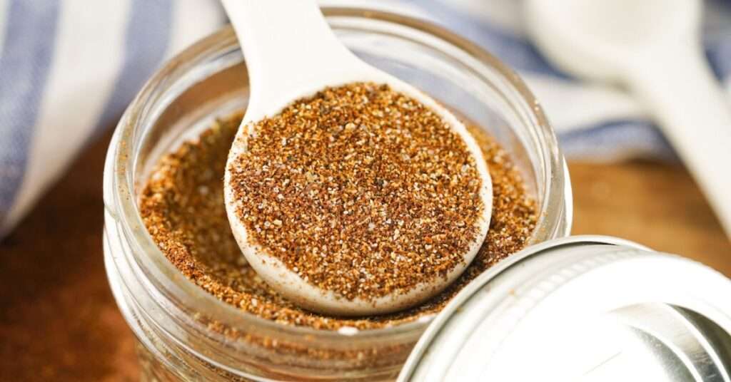 Homemade chili Seasoning spooned out of a mason jar