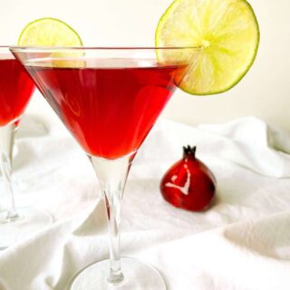Perfect Pomegranate Cosmo garnished with fresh lime slices