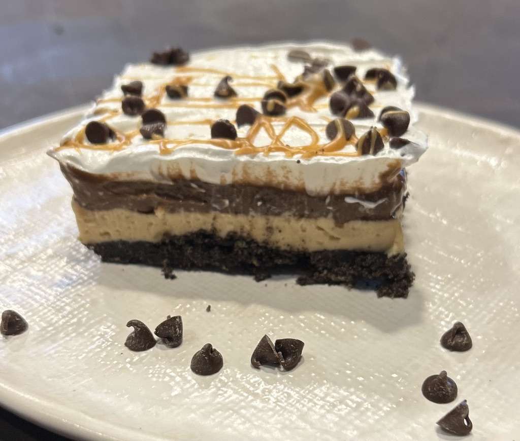Slice of Chocolate Peanut Butter Lasagna  on a white plate.