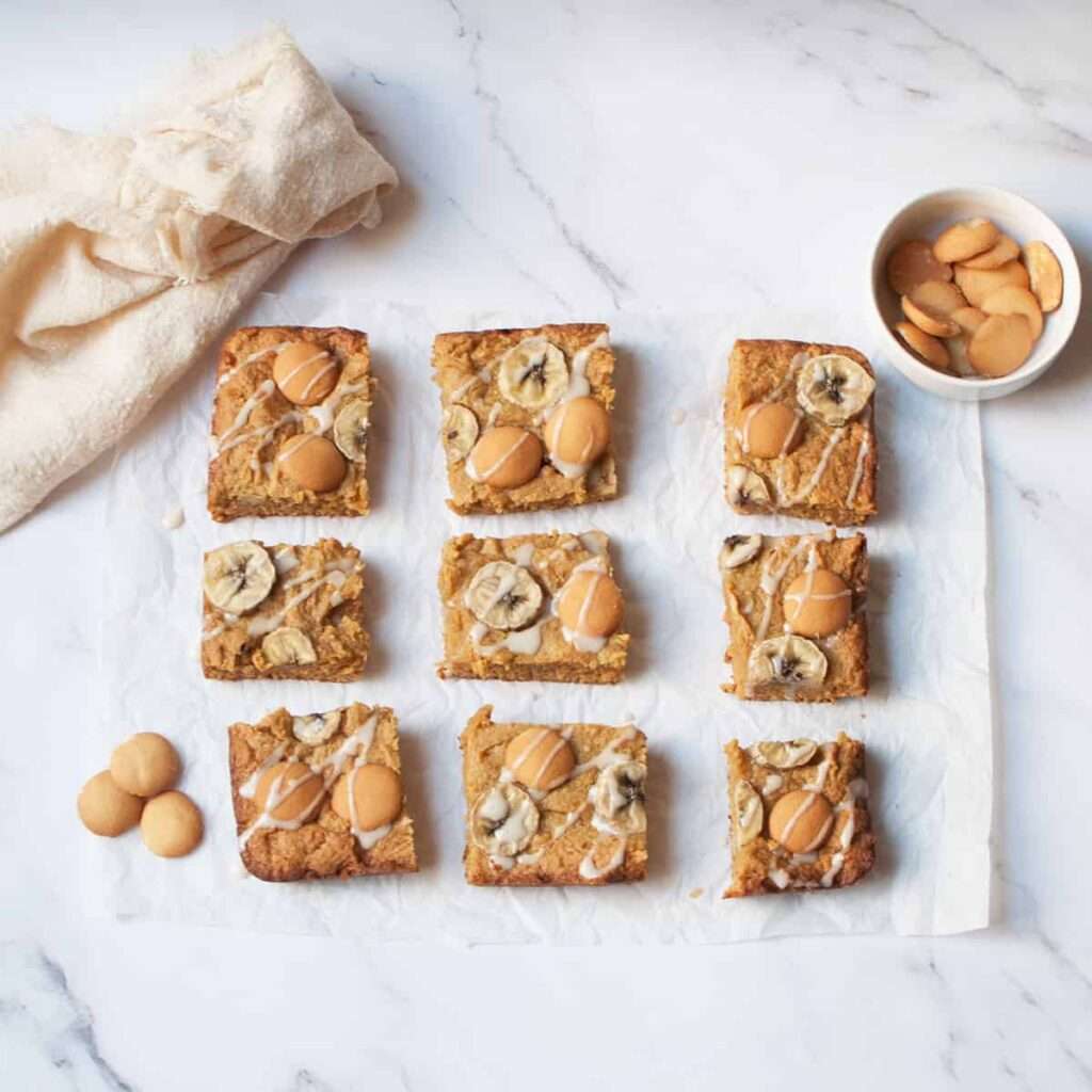 23 Fun Facts About Bananas Banana blondie bars topped with banana slices, vanilla wafers, and glaze.