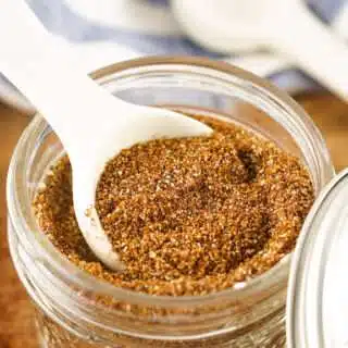 Chili seasoning being measured from a mason jar