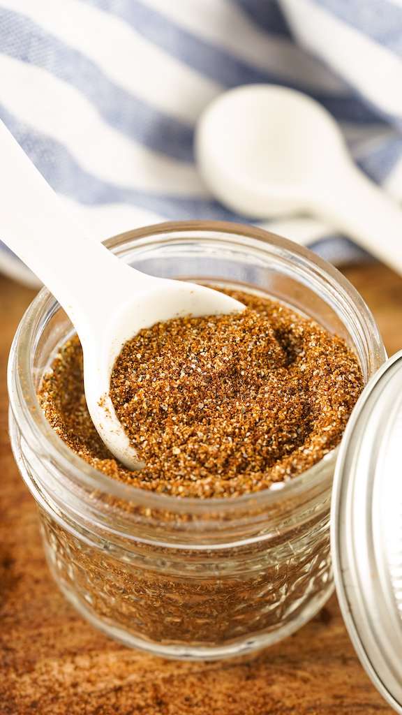 Chili seasoning being measured from a mason jar