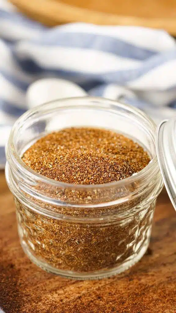 A mason jar filled with chili seasoning made from scratch.