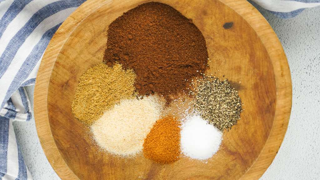 Homemade Chili Seasoning Ingredients in a wooden bowl.