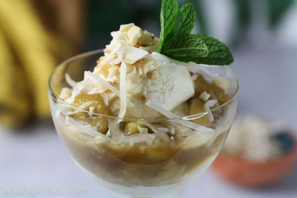 23 Fun Facts About Bananas Banana coconut sundae with vanilla ice cream, caramelized bananas, shaved coconut, and mint garnish in a glass