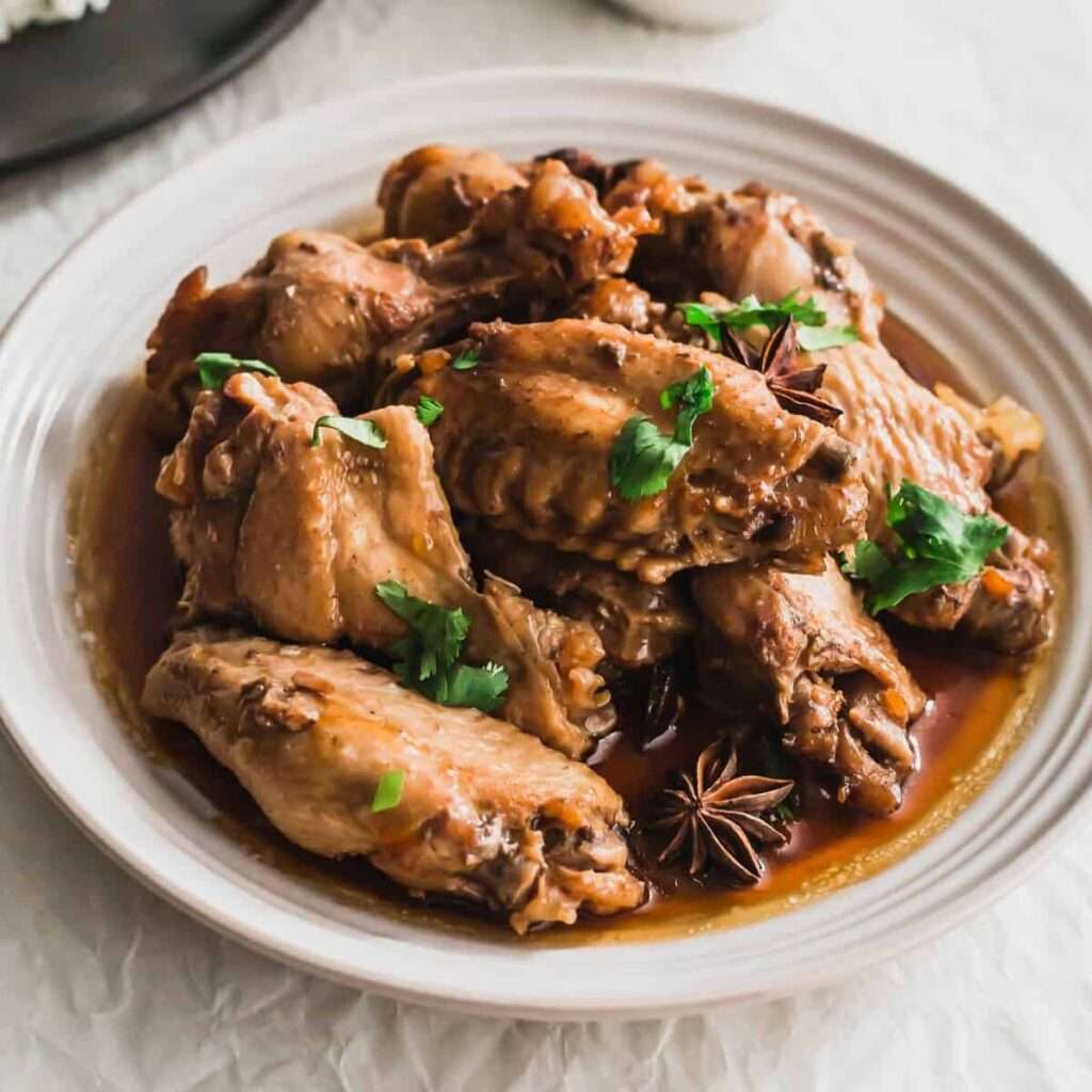 7 Instant Pot Chicken Wing Recipes You'll Love Braised chicken wings in soy sauce with star anise and cilantro on a plate